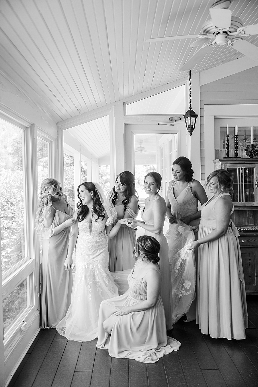 Bridesmaids help bride get ready at Marblegate Wedding by Amanda May Photos