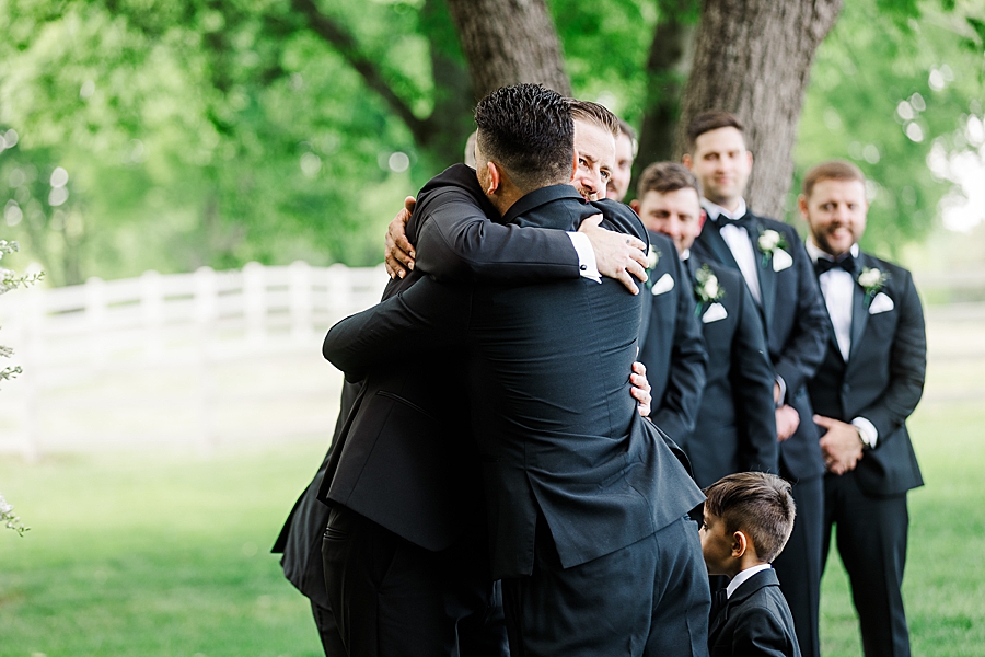 Groomsmen hugging groom at Marblegate Wedding by Amanda May Photos