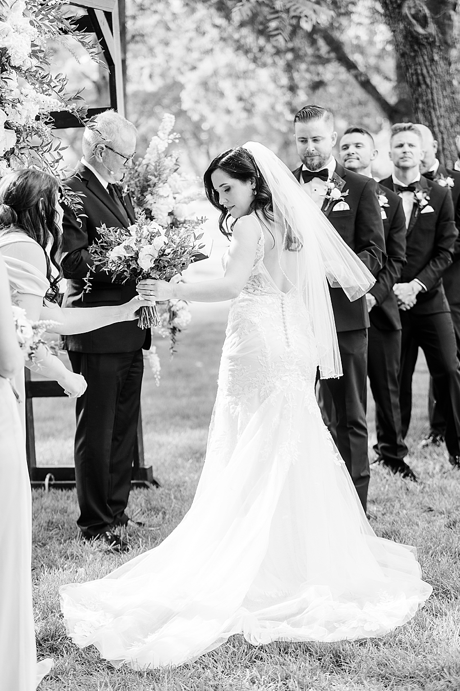 Bride hands flowers off at Marblegate Wedding by Amanda May Photos