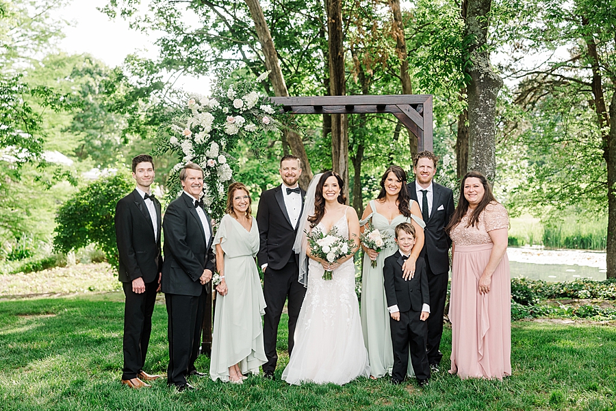Bride and groom with family at wedding by Amanda May Photos