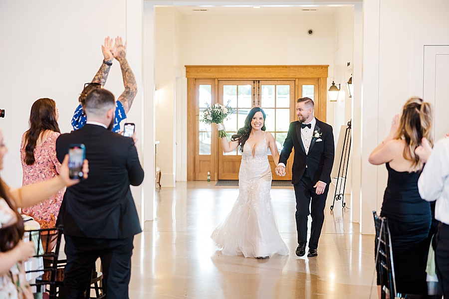 Bride and groom enter reception at wedding by Amanda May Photos