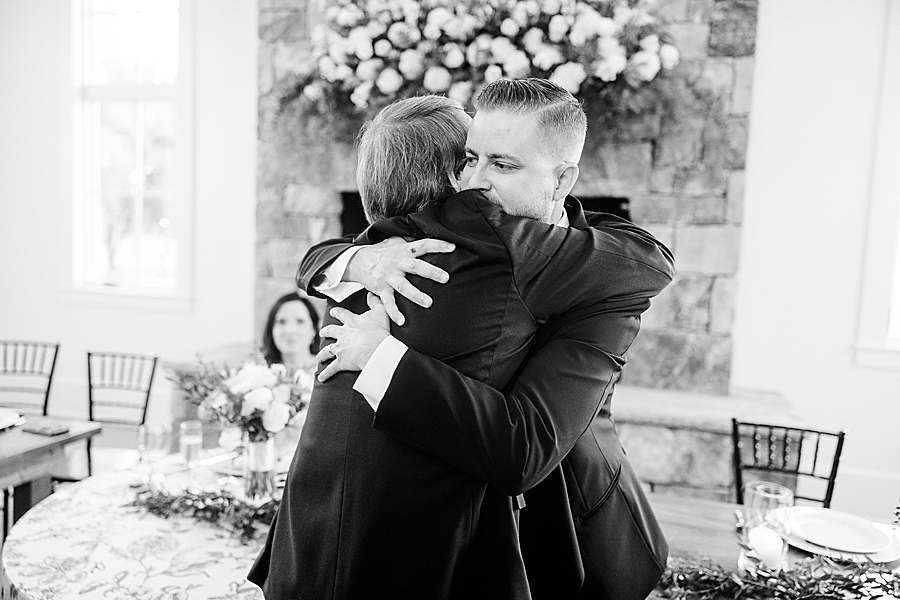 Groom hugging dad at wedding by Amanda May Photos