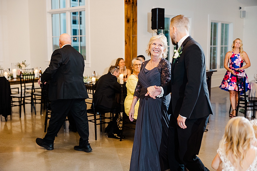 Groom dancing with mom at wedding by Amanda May Photos
