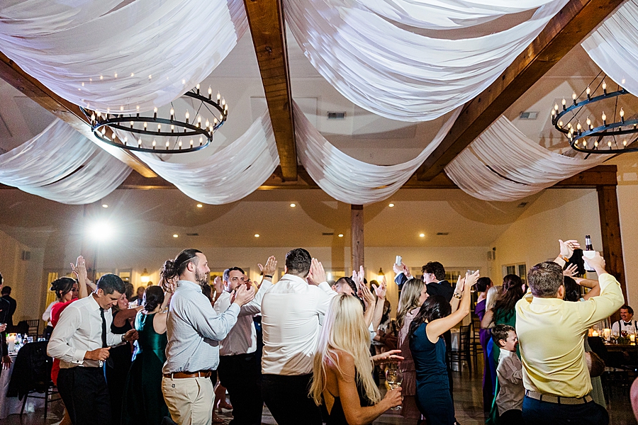 Guests celebrate on the dance floor at wedding by Amanda May Photos
