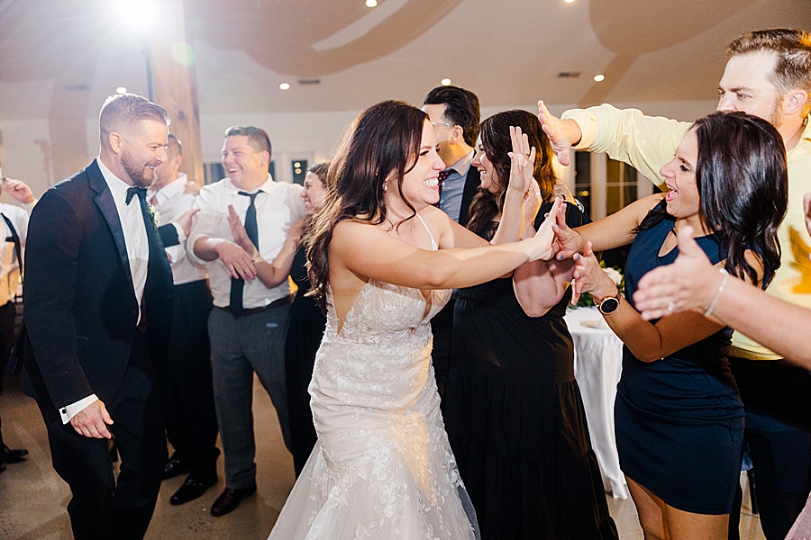Bride and groom give high fives at wedding by Amanda May Photos