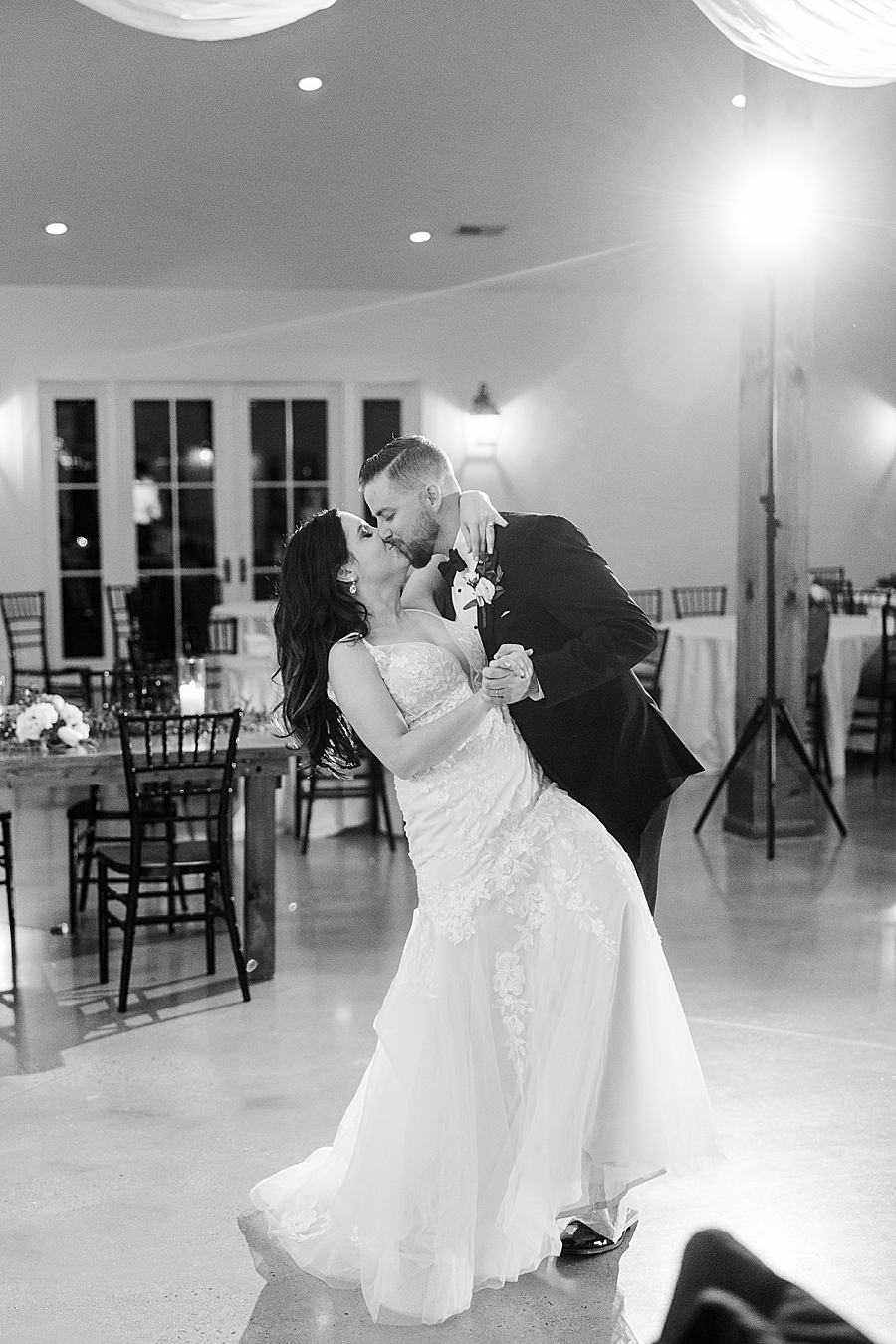 Bride and groom kiss on dance floor at wedding by Amanda May Photos