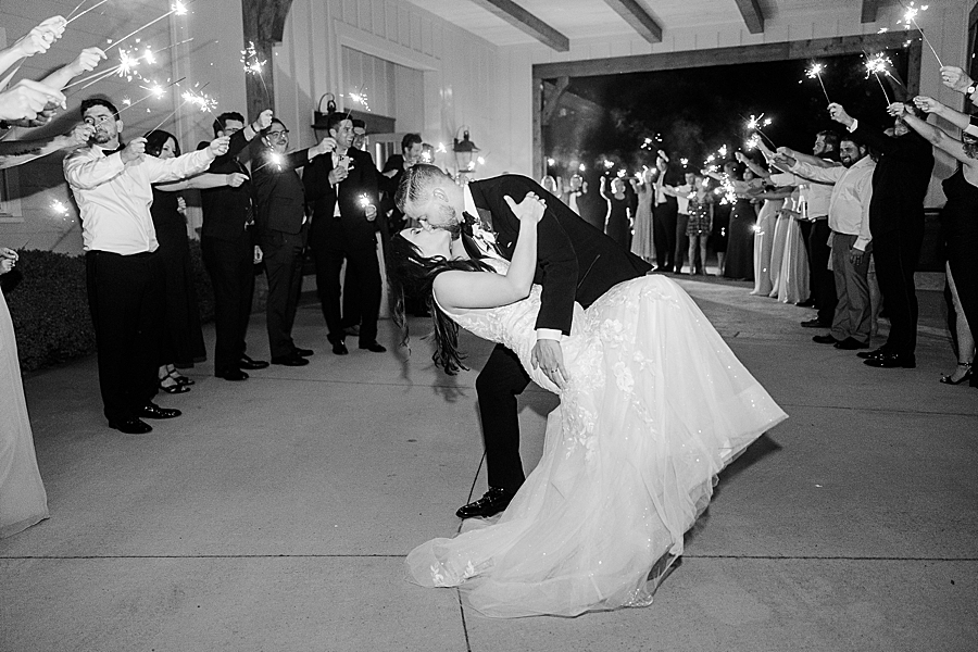 Bride and groom kiss at wedding by Amanda May Photos