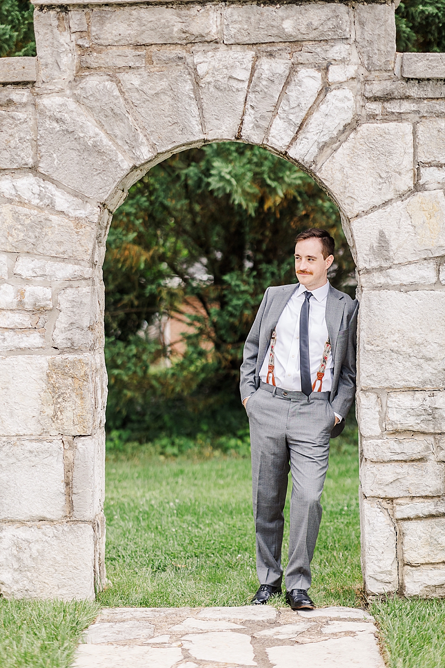 groom in stone archway