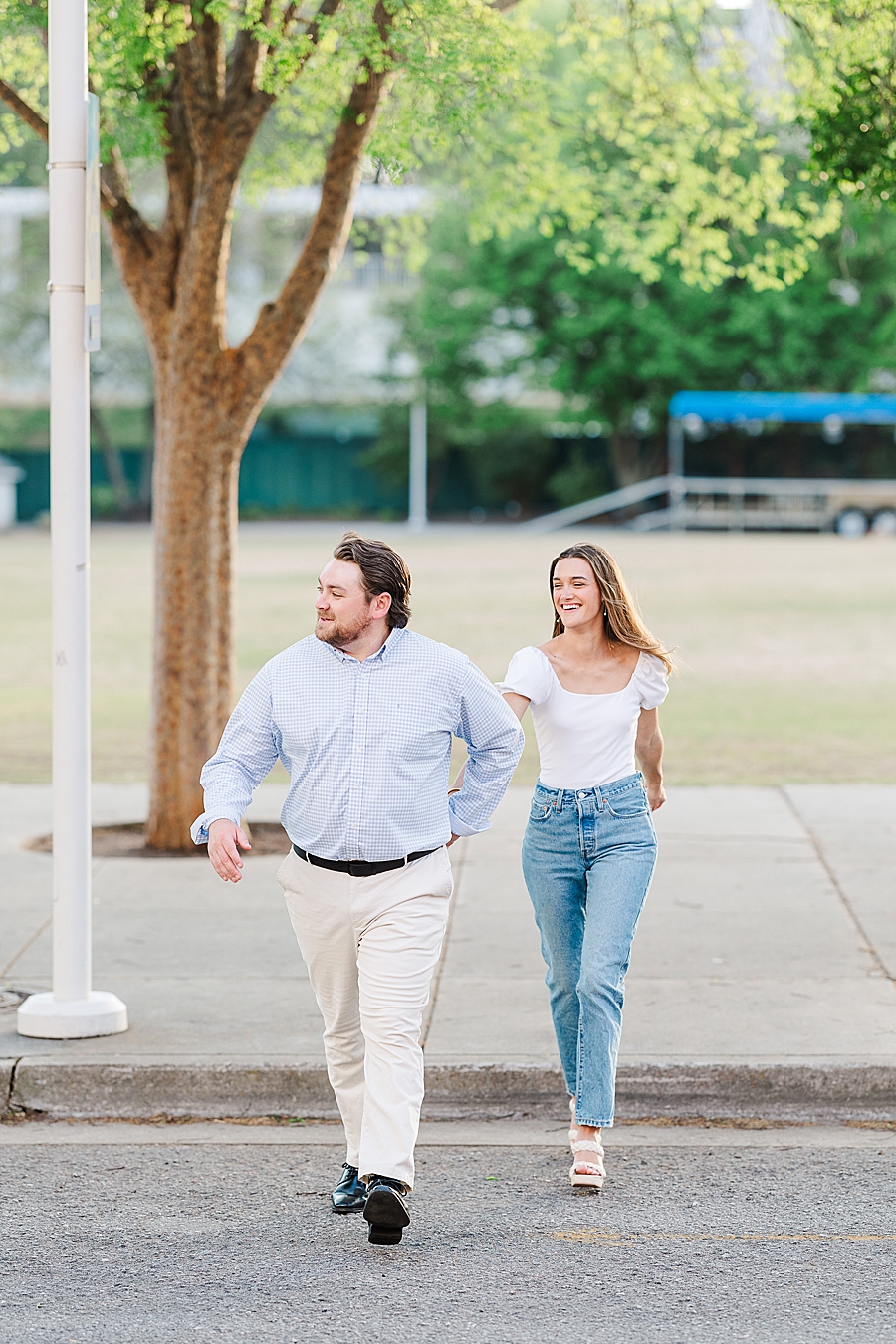 couple walking across street at knoxville engagement session
