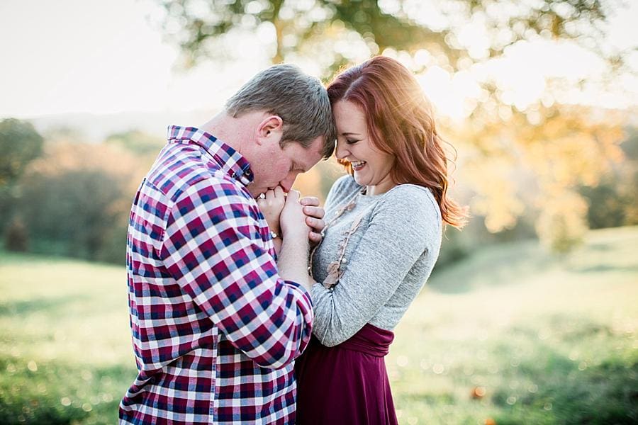 Kissing her hands at this Biltmore Estate engagement session by Knoxville Wedding Photographer, Amanda May Photos.