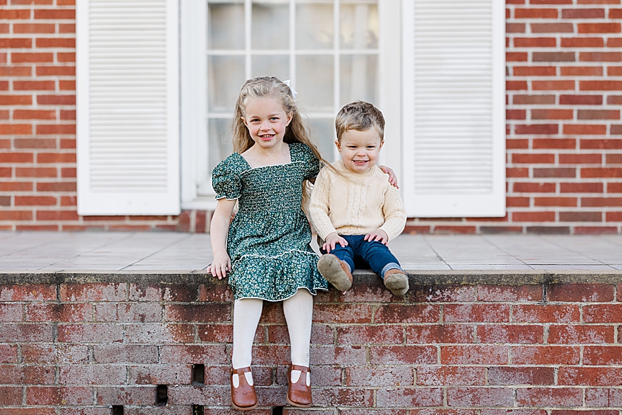 kids sitting on brick wall in lenoir city