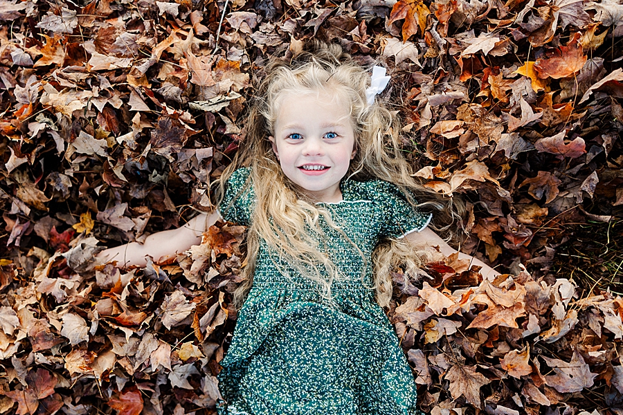 girl laying in leaves in lenoir city