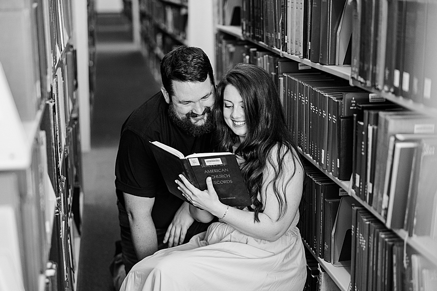 couple reading at library engagement photos