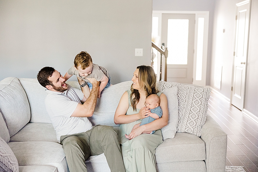 family in living room at lifestyle newborn session