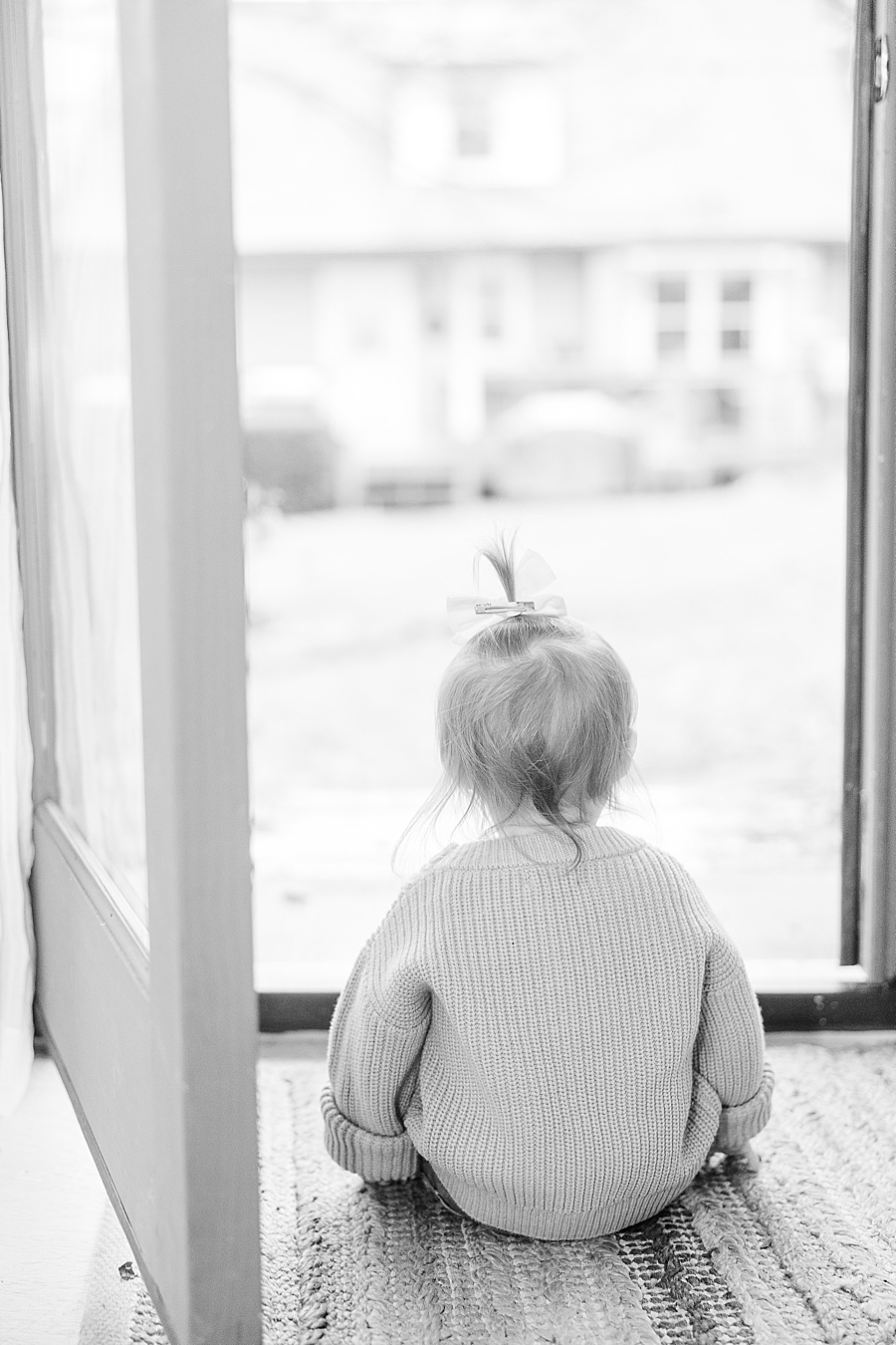 little girl sitting at door