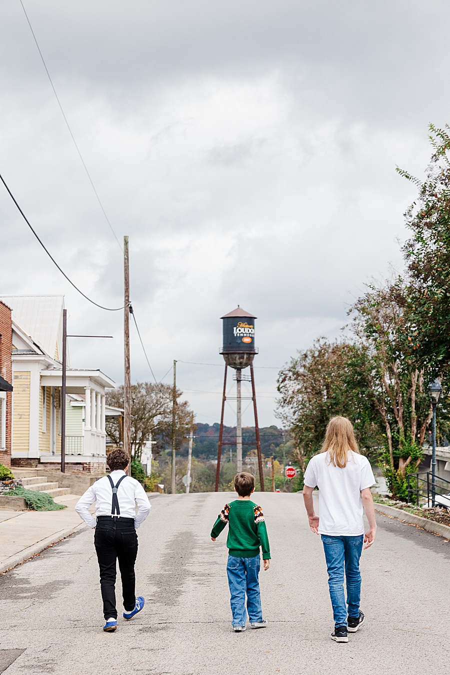 3 boys walking towards water tower