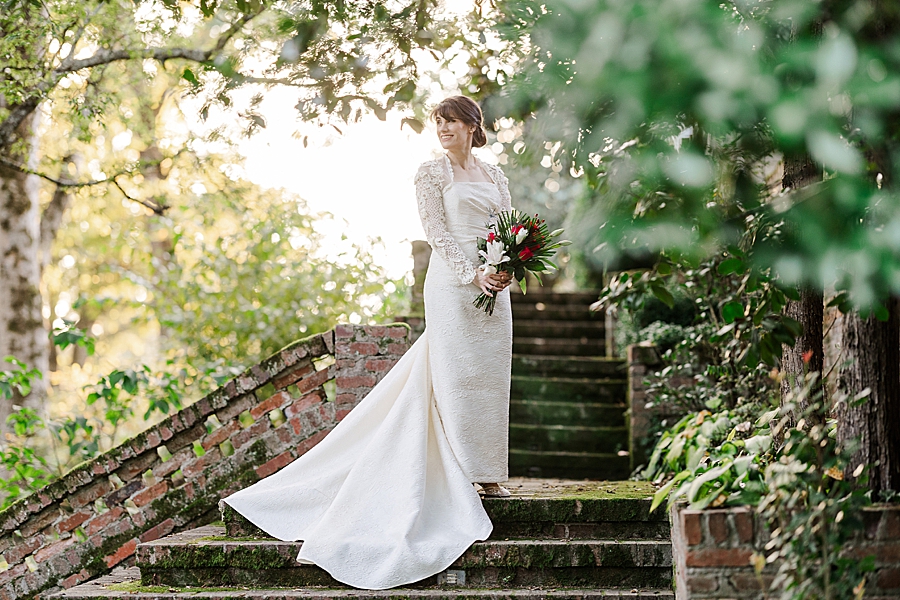 bride standing on mossy stairs