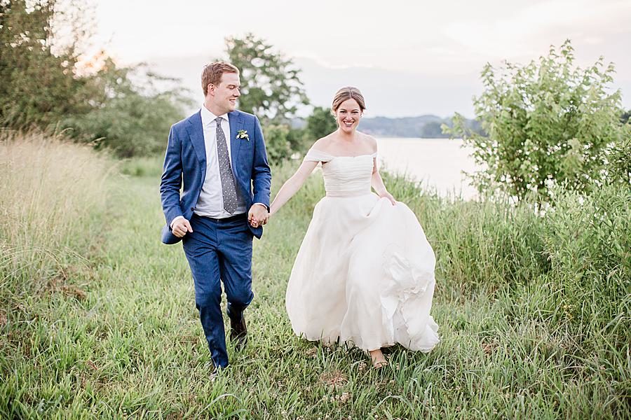 Running through a field at this Marblegate Farm Wedding by Knoxville Wedding Photographer, Amanda May Photos.