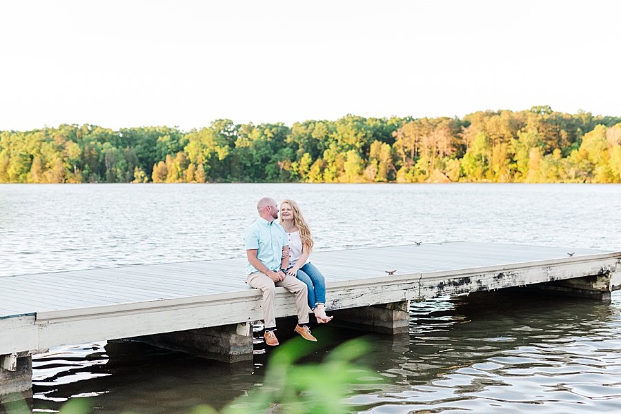 couple sitting on dock at marblegate farm associate session