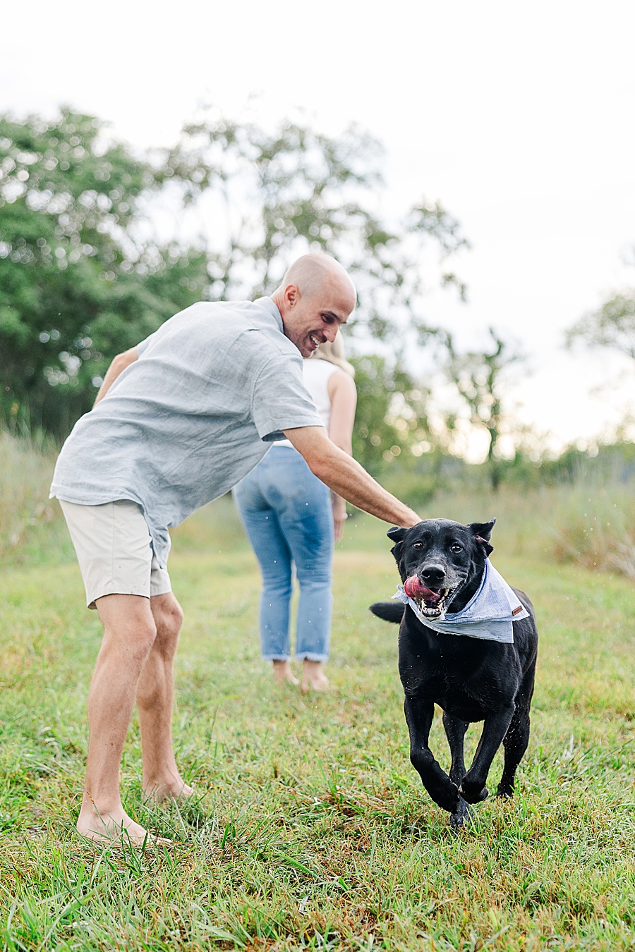 couple playing with dogs at marblegate farm