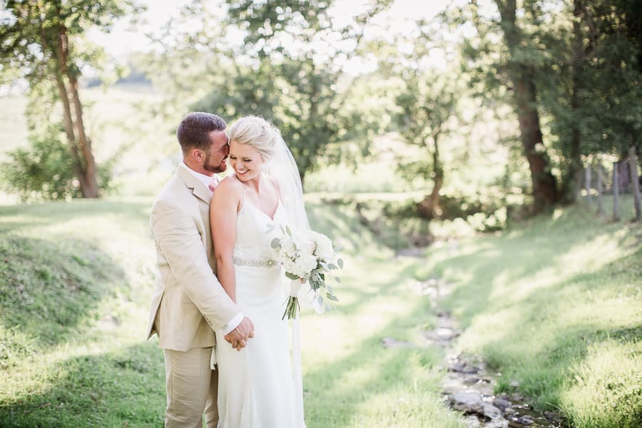Groom whispering in the bride's ear at this Neltner's Farm Wedding by Knoxville Wedding Photographer, Amanda May Photos.