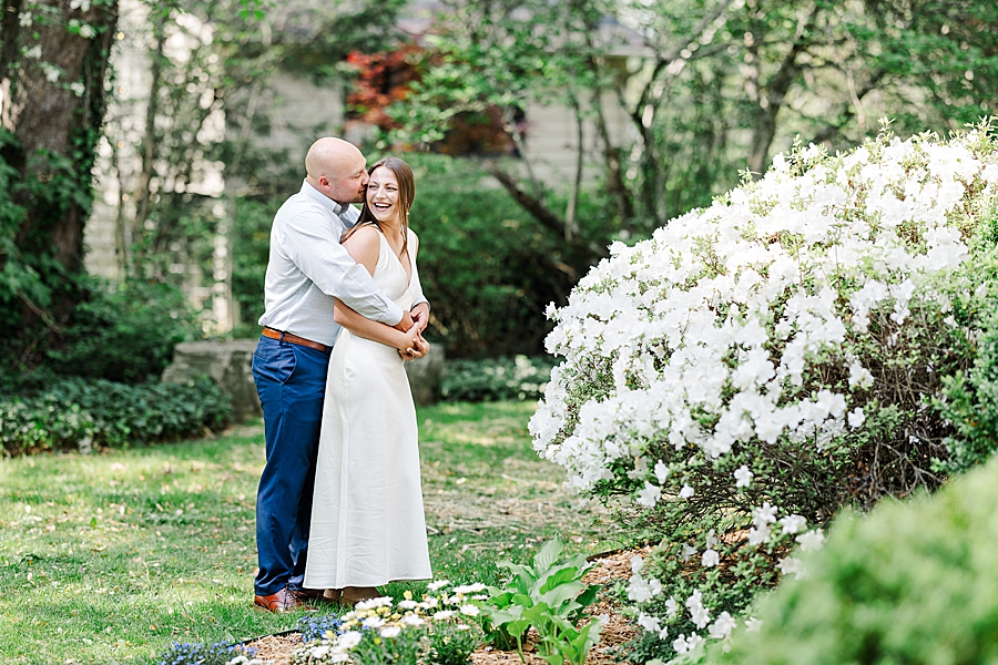 couple standing by white azalea