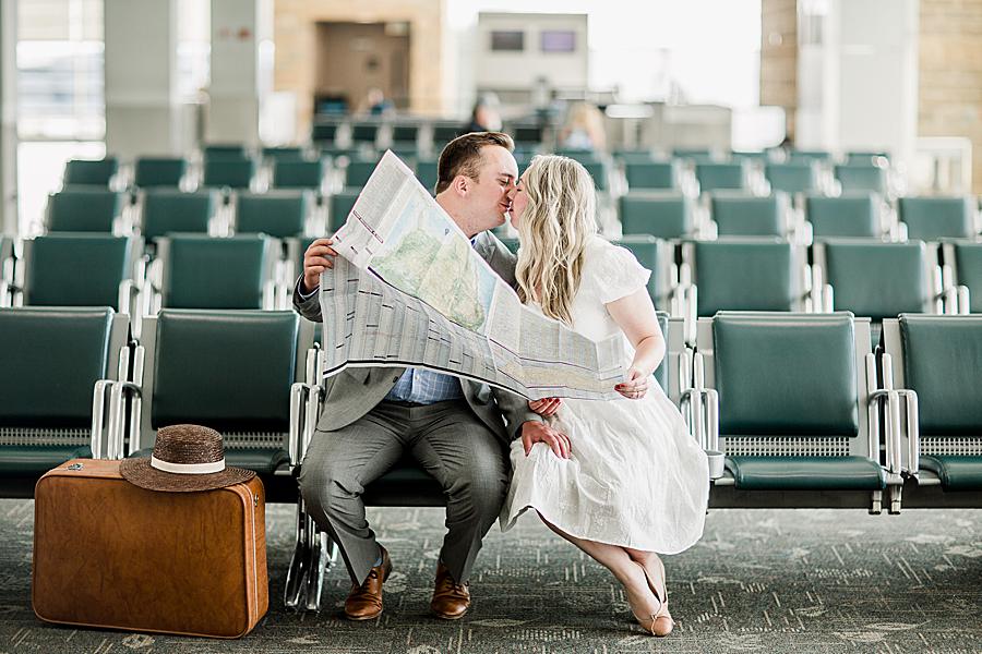 Sitting in the airport seats kissing at this McGhee Tyson Airport Engagement by Knoxville Wedding Photographer, Amanda May Photos