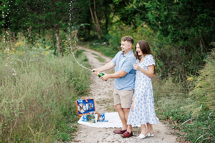 popping champagne at meads quarry engagement