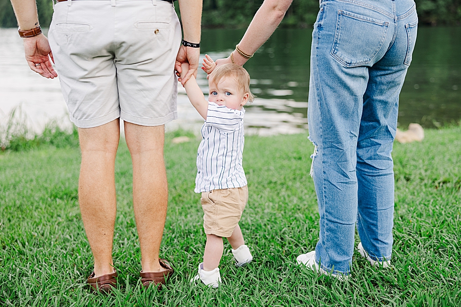 parents holding son's hands