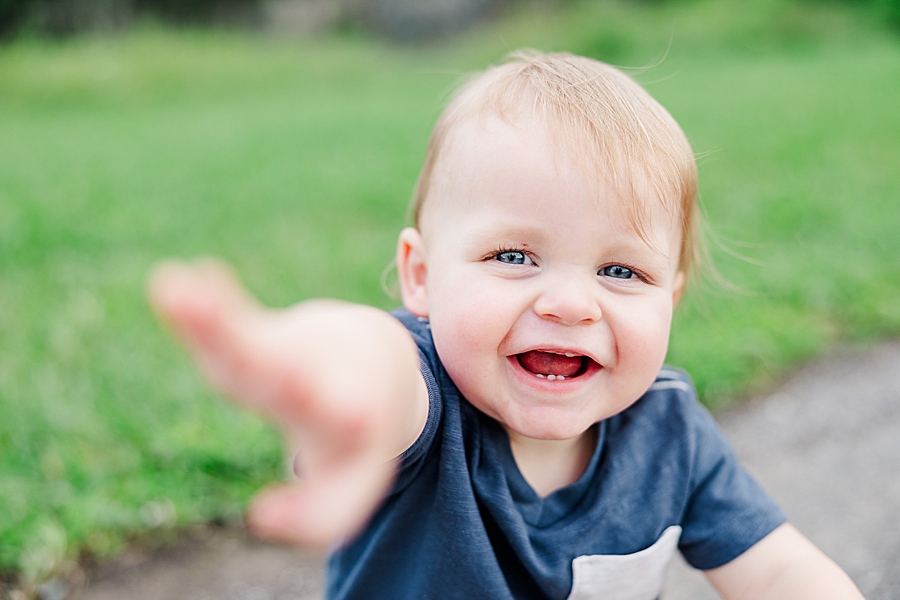 little boy reaching for camera