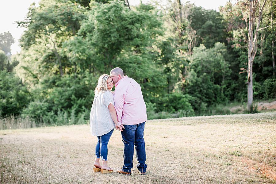 Kissing in a field at this Morristown engagement by Knoxville Wedding Photographer, Amanda May Photos.