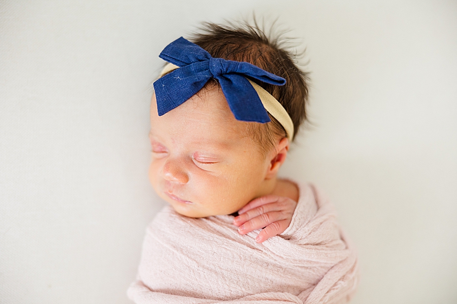 newborn in blue bow