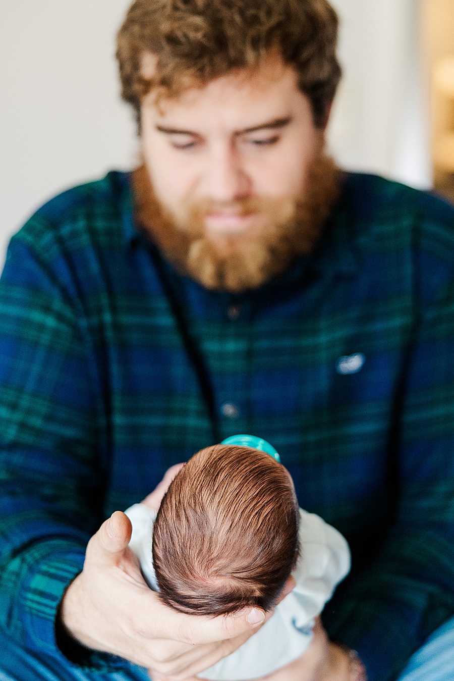 father holding newborn son