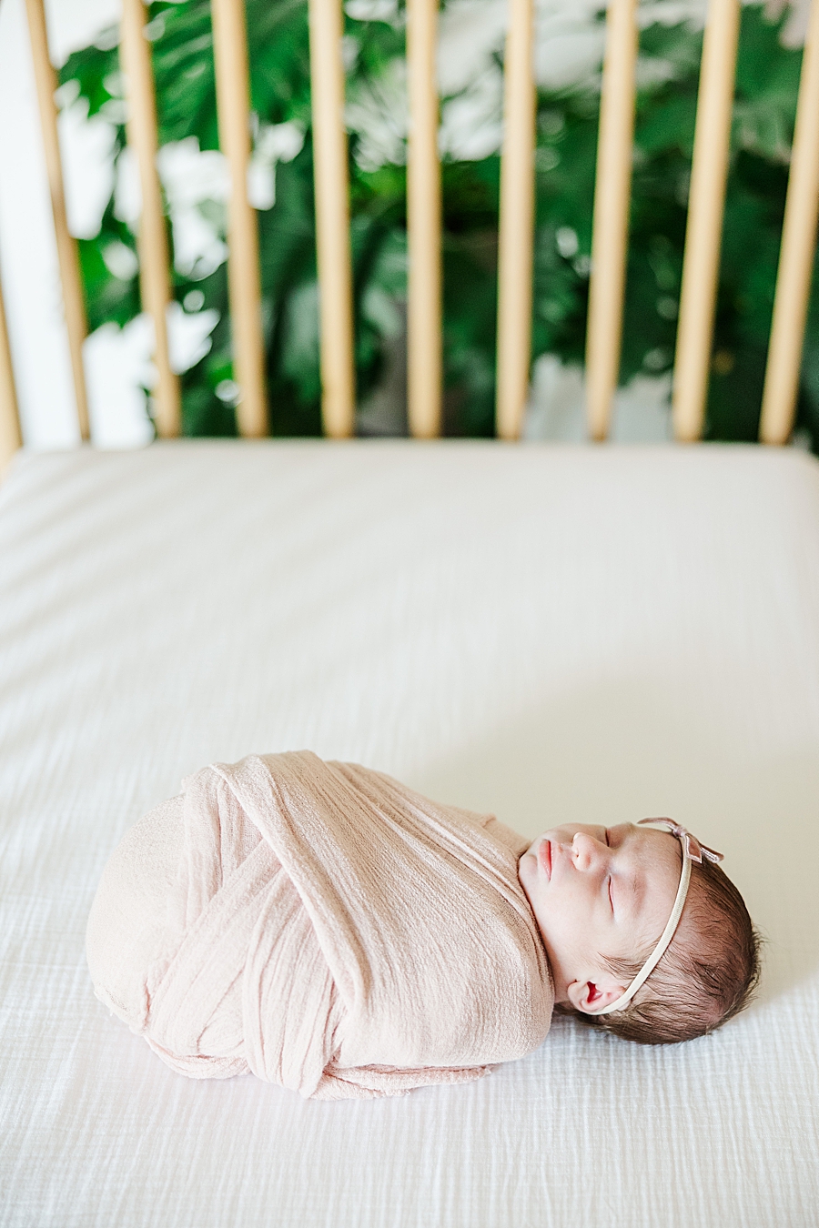 baby girl swaddled in crib