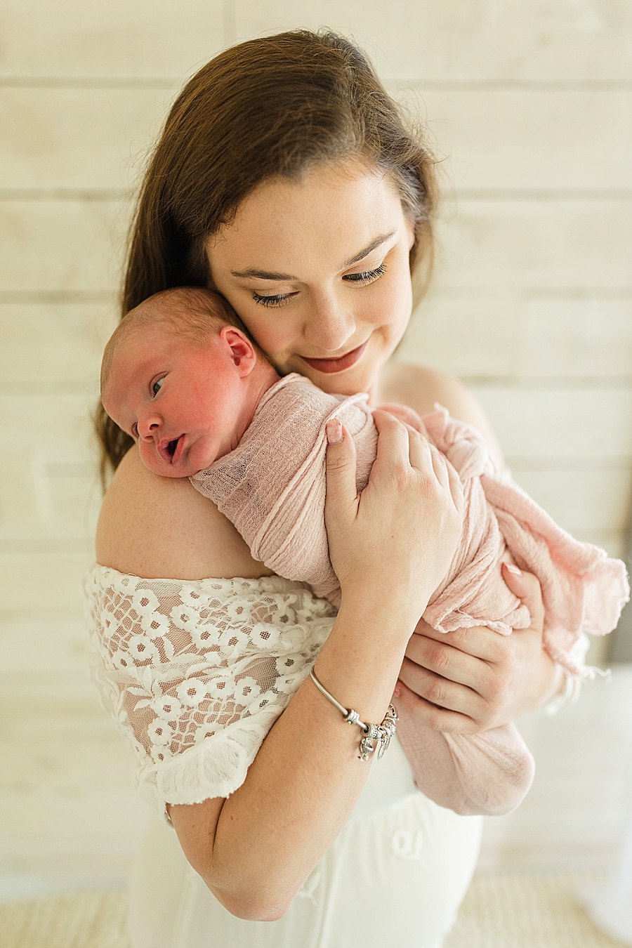 mom holding baby girl at this newborn session