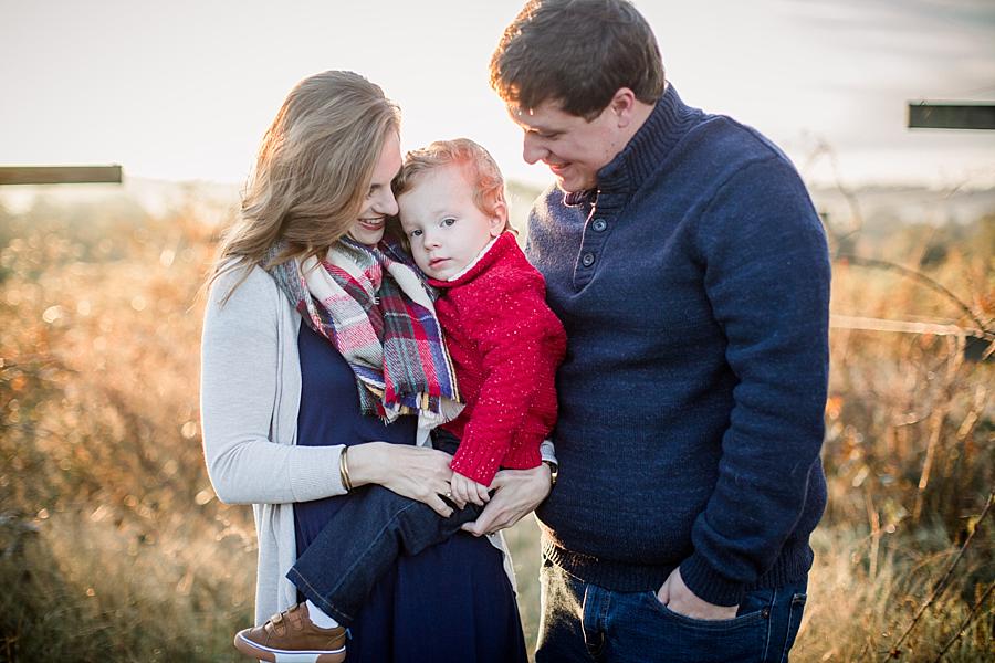 Looking at their son at this sunrise family session at the Fruit and Berry Patch by Knoxville Wedding Photographer, Amanda May Photos.