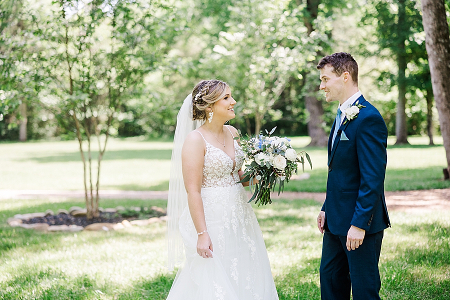 Bride and groom talking at Ramble Creek wedding by Amanda May Photos
