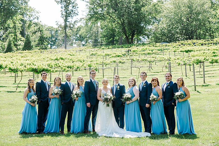 Wedding party standing with bride and groom at Ramble Creek wedding by Amanda May Photos