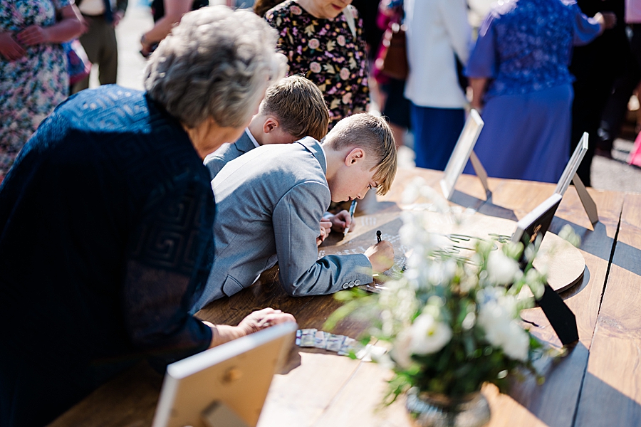 Guests signing in at wedding by Amanda May Photos