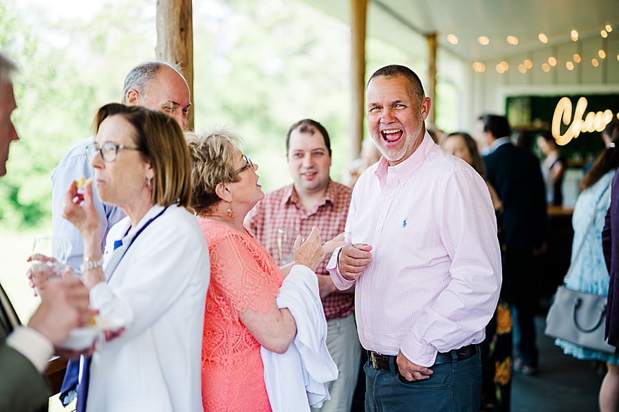 Guests laughing at wedding by Amanda May Photos