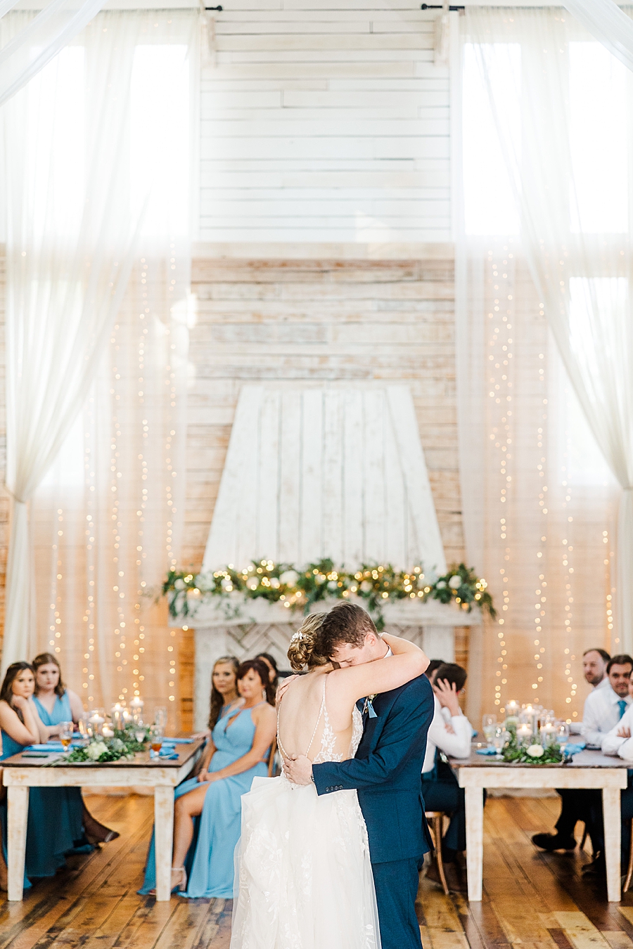 Bride and groom hug while dancing at wedding by Amanda May Photos