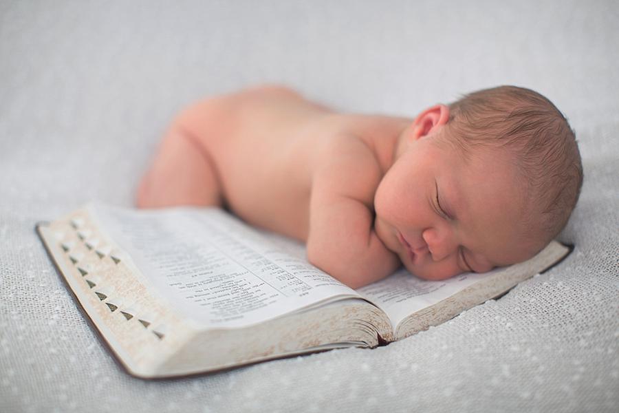 Laying on a Bible at this newborn girl photo session by Knoxville Wedding Photographer, Amanda May Photos.