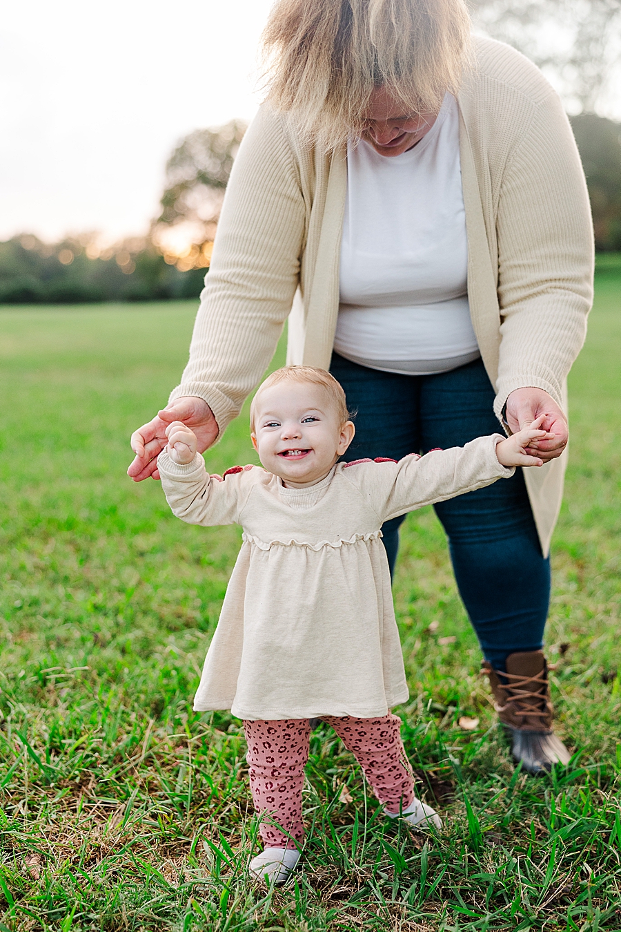 mom helping daughter walk