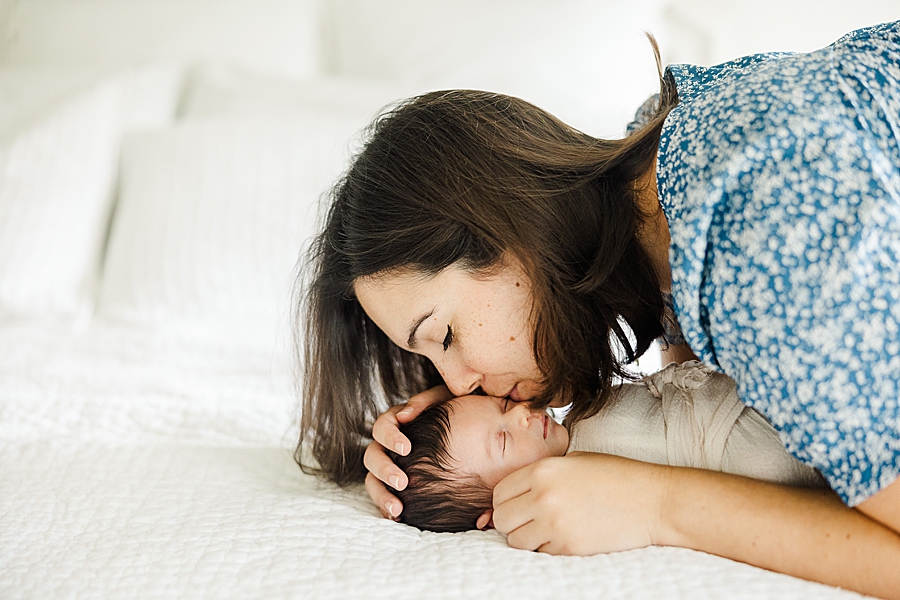 mama kissing newborn