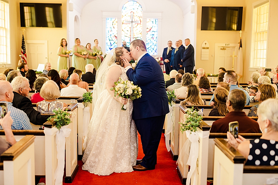 bride and groom kissing at st mark umc