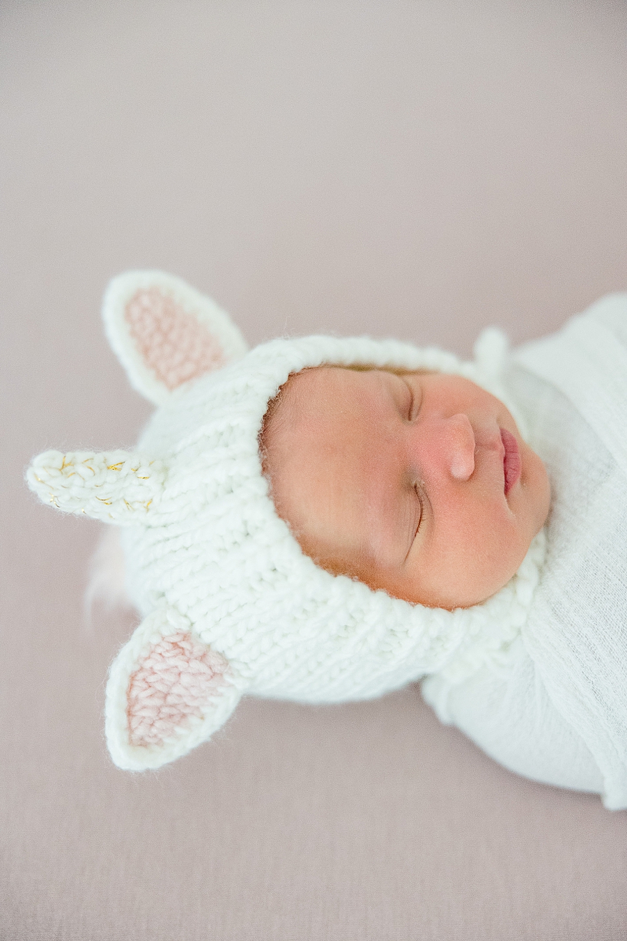 baby in unicorn hat at studio newborn