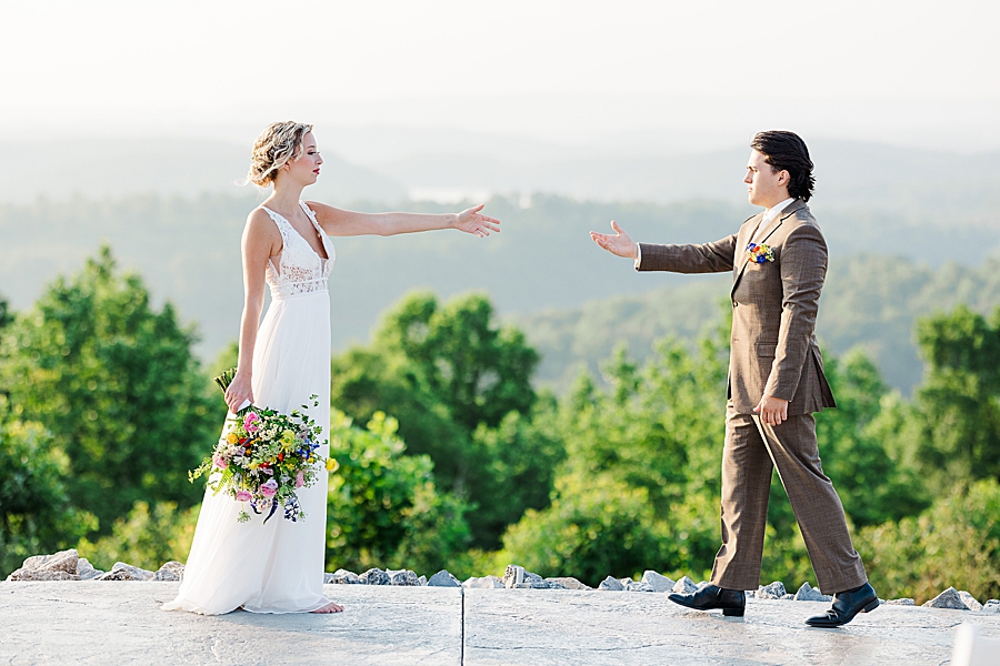 Reaching hands out to each other at The Loyston Wedding Venue by Amanda May Photos