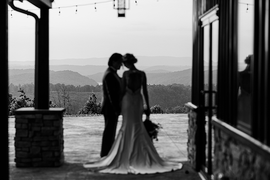 Bride and groom standing in front of mountain view at styled shoot by Amanda May Photos
