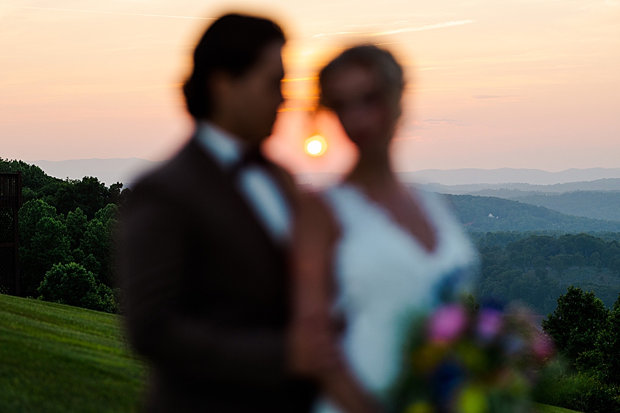 Bride and groom in front of sunset at styled shoot by Amanda May Photos