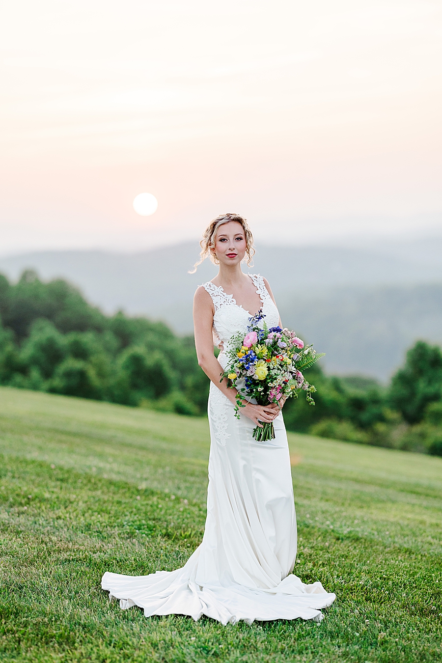 Bride holding bouquet in front of mountains at styled shoot by Amanda May Photos